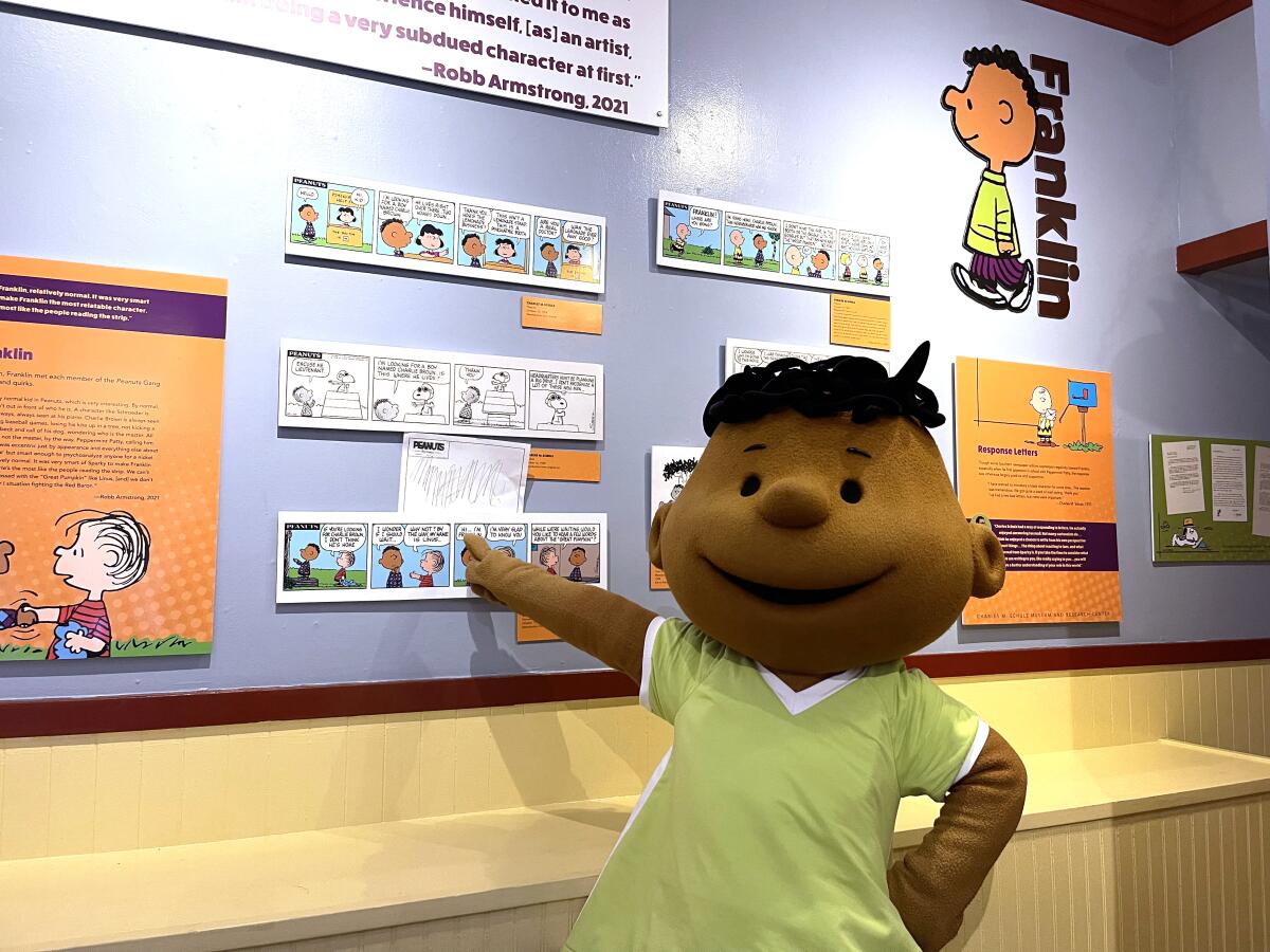 "Franklin" points out a "Peanuts" comic strip featuring his character.