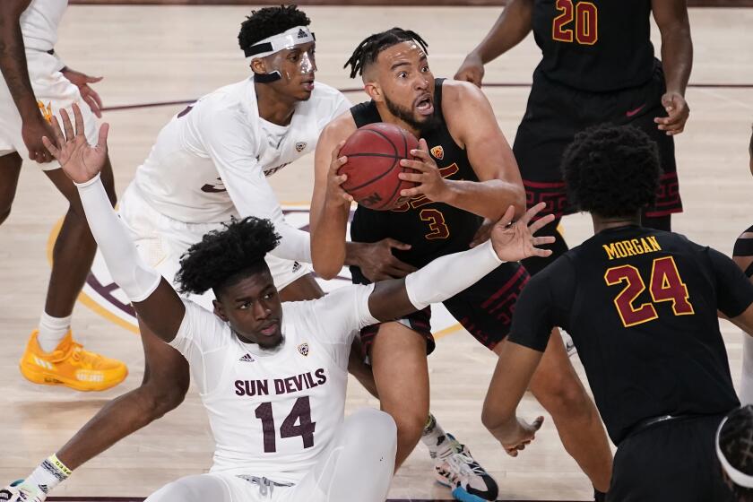 CORRECTS LOCATION TO TEMPE, INSTEAD OF PHOENIX - Southern California forward Isaiah Mobley (3) looks to shoot as Arizona State center Enoch Boakye (14) and forward Alonzo Gaffney, top left, defend during the second half of an NCAA college basketball game Thursday, Feb. 3, 2022, in Tempe, Ariz. (AP Photo/Matt York)