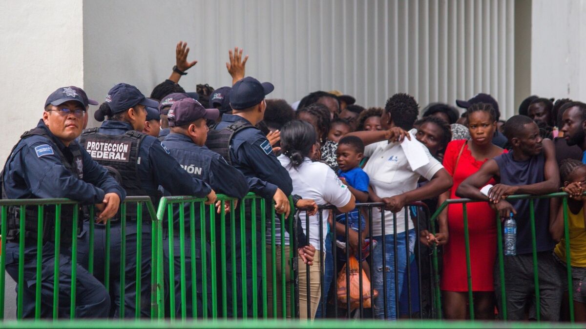 People who arrived from Guatemala seeking legal documentation in Mexico gather outside the offices of Mexico's National Institute of Immigration in Tapachula, Mexico, on June 12, 2019.