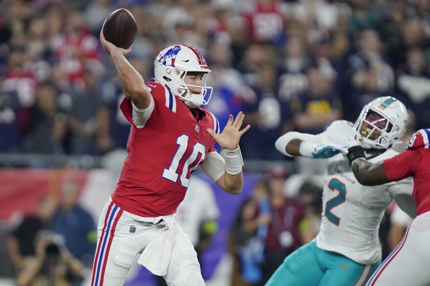New England Patriots quarterback Mac Jones (10) throws a pass while pressured by Miami Dolphins linebacker Bradley Chubb (2) during the first half an NFL football game, Sunday, Sept. 17, 2023, in Foxborough, Mass. (AP Photo/Steven Senne)