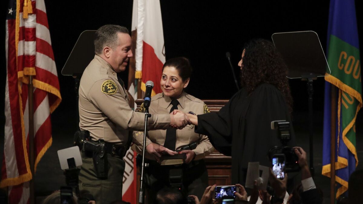 L.A. County Sheriff Alex Villanueva is congratulated by Judge Lucy Armendariz, right, after he was sworn in in 2018.