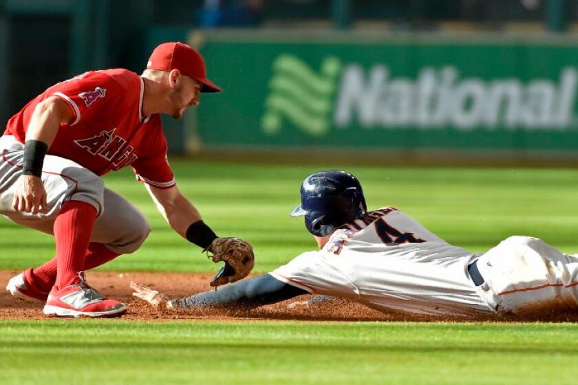 Angels second baseman Johnny Giavotella tags out Astros outfielder George Springer during a game on July 23.