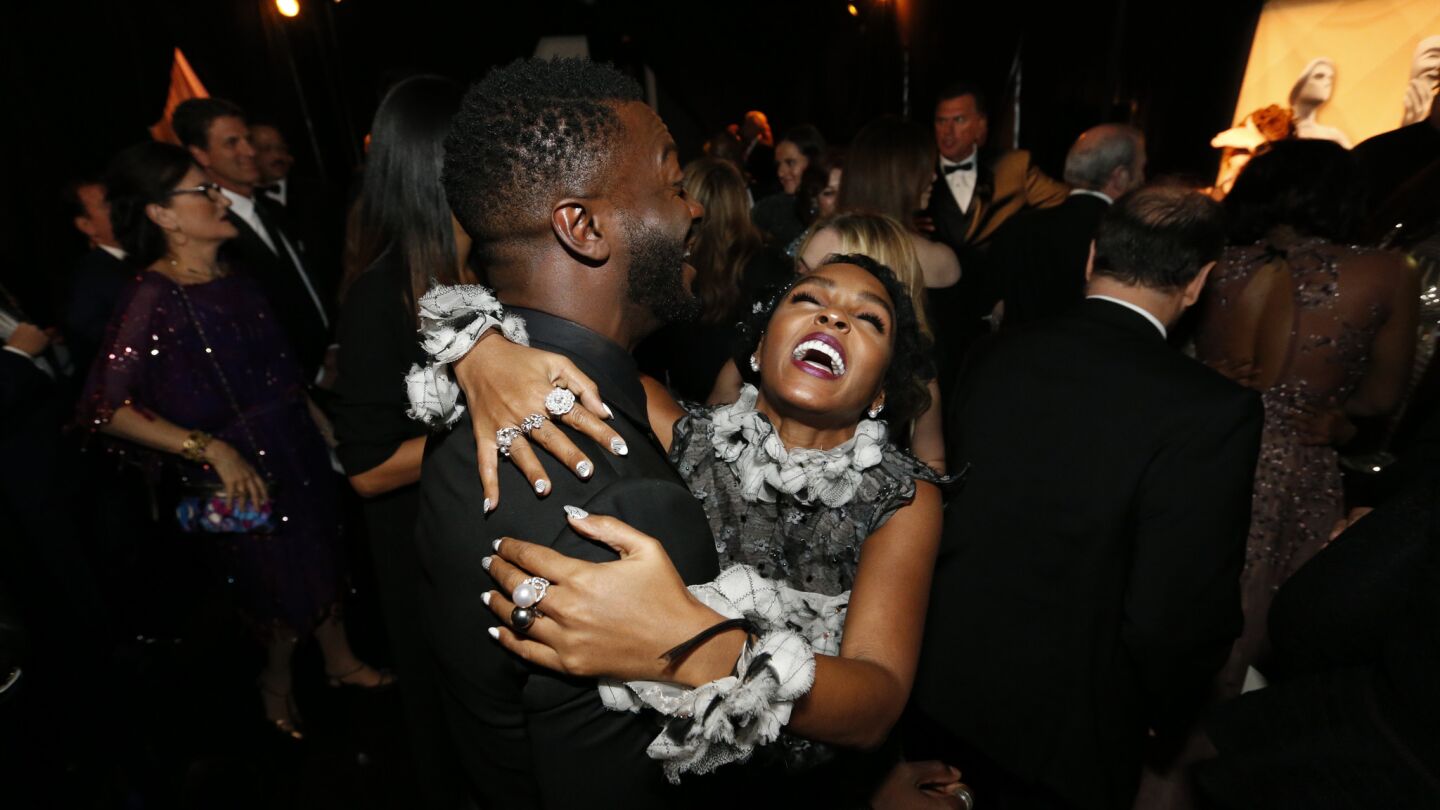 Janelle Monae and Aldis Hodge embrace backstage after winning for Outstanding Performance by a Cast in a Theatrical Motion Picture for "Hidden Figures."
