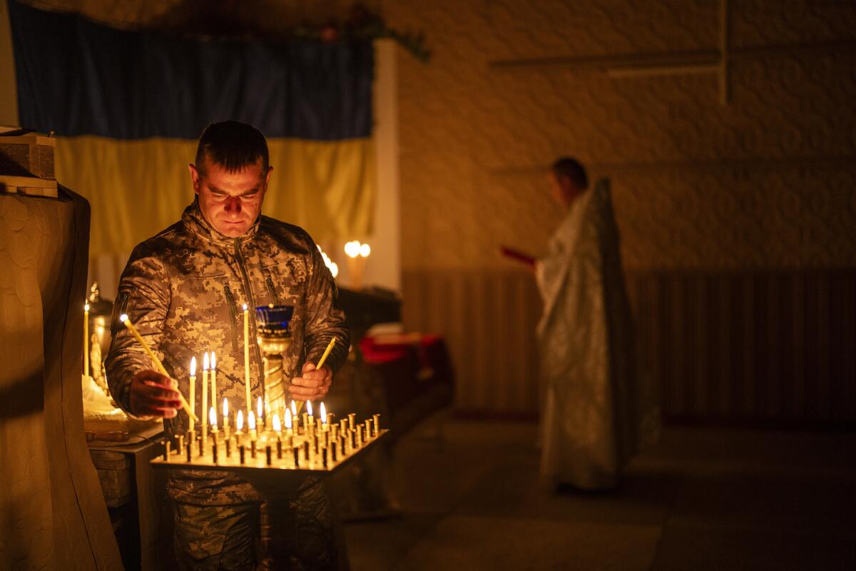 A Ukrainian serviceman lights candles during a Christian Orthodox Easter religious service.