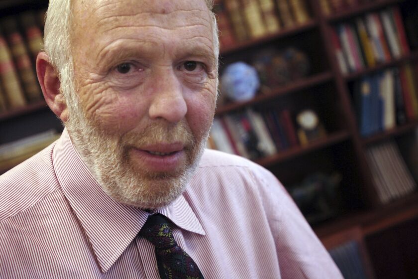FILE — Jim Simons, a businessman and founder of Math for America, poses at his New York office, Dec. 14, 2005. The Simons Foundation, a New York-based charity that supports math and science research, announced a $500 million gift, Thursday, June 1, 2023, to Stony Brook University, a public institution where founder Simons was a math professor before he became a billionaire hedge fund manager. (AP Photo/Jason DeCrow, File)