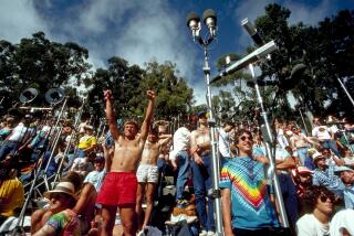 Concertgoers stand and cheer amongst microphones being used to record a Grateful Dead show in Berkeley, Calif. in 1987.
