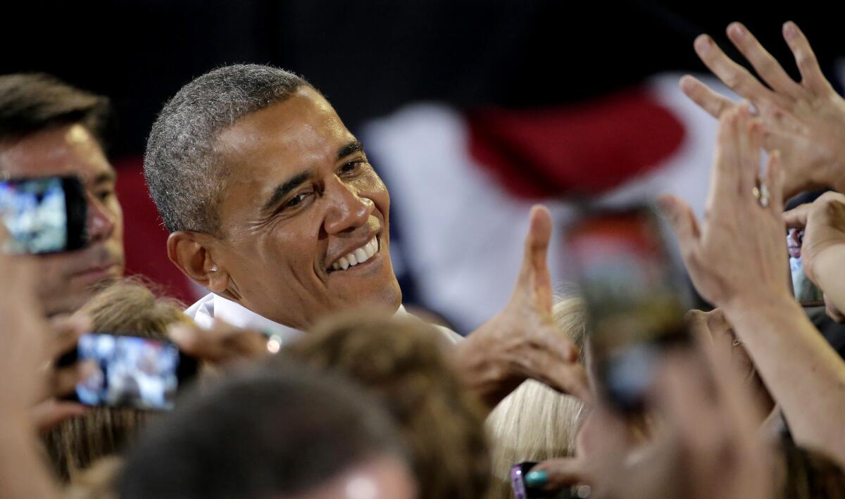 President Obama greets audience members after speaking Wednesday at the Uptown Theatre in Kansas City, Mo.