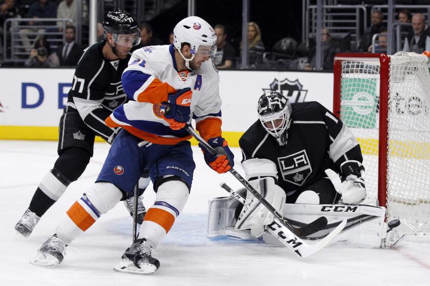 Kings goalie Jhonas Enroth stops a shot from New York Islanders center Frans Nielsen during the first period of a game on Nov. 12.
