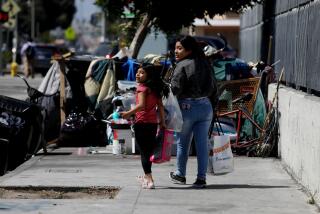 LOS ANGELES, CA - JULY 06: A young girl and a woman look before walking into the street to get around a homeless encampment blocking the sidewalk along the 7200 block of Vermont at Florence in South Central on Thursday, July 6, 2023 in Los Angeles, CA. A liberal-leaning three-judge panel of the appellate court gave homeless people with nowhere else to go have a right to sleep in public. (Gary Coronado / Los Angeles Times)