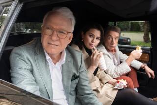 Three people looking out the window of a car as they sit in the back eating fast food. 