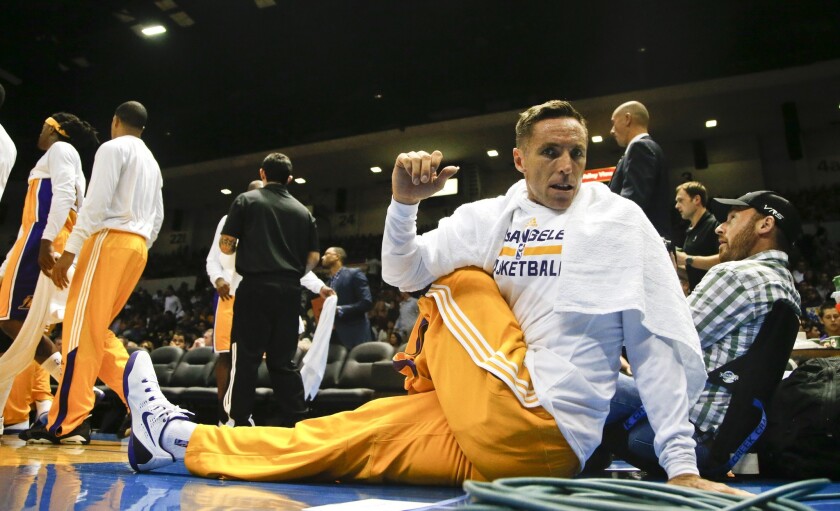 Lakers guard Steve Nash stretches his back out during the first half of a preseason game Monday in San Diego against the Denver Nuggets.