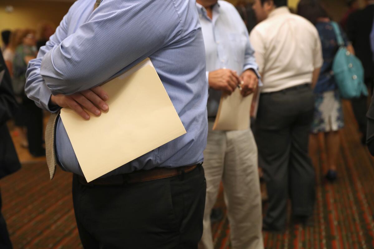 Applicants wait to speak with potential employers at a job fair in Hartford, Conn., on Sept. 19.