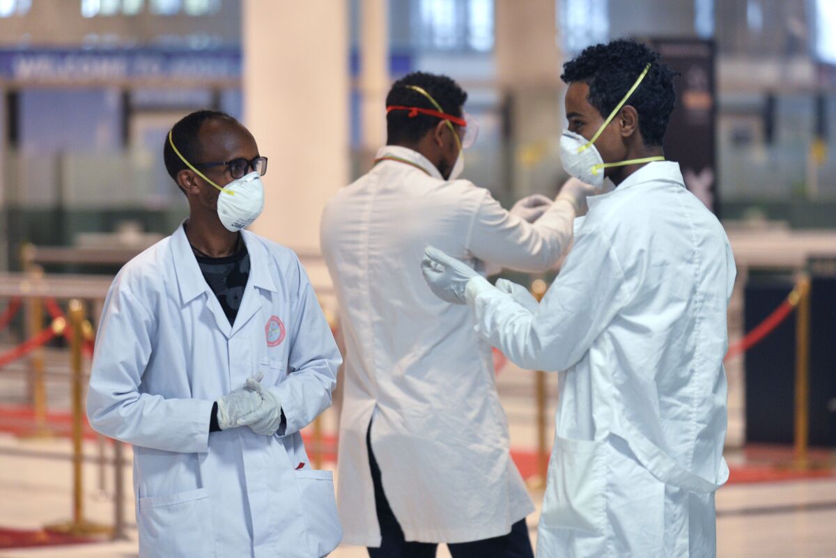 Ethiopian health workers prepare to screen passengers for COVID-19 at the Addis Ababa airport