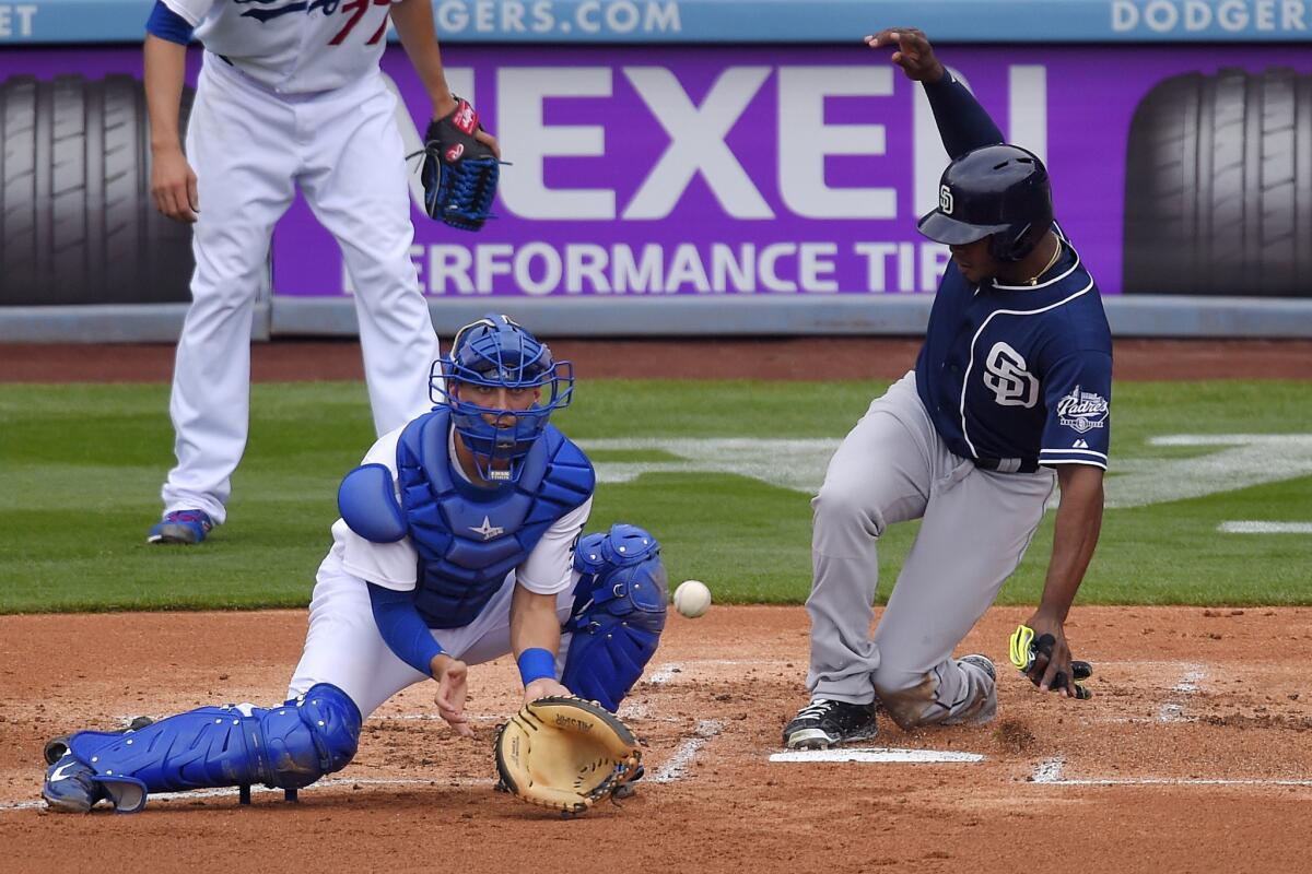 Dodgers catcher Austin Barnes takes a late throw while Padres outfielder Justin Upton scores on May 24, 2015.