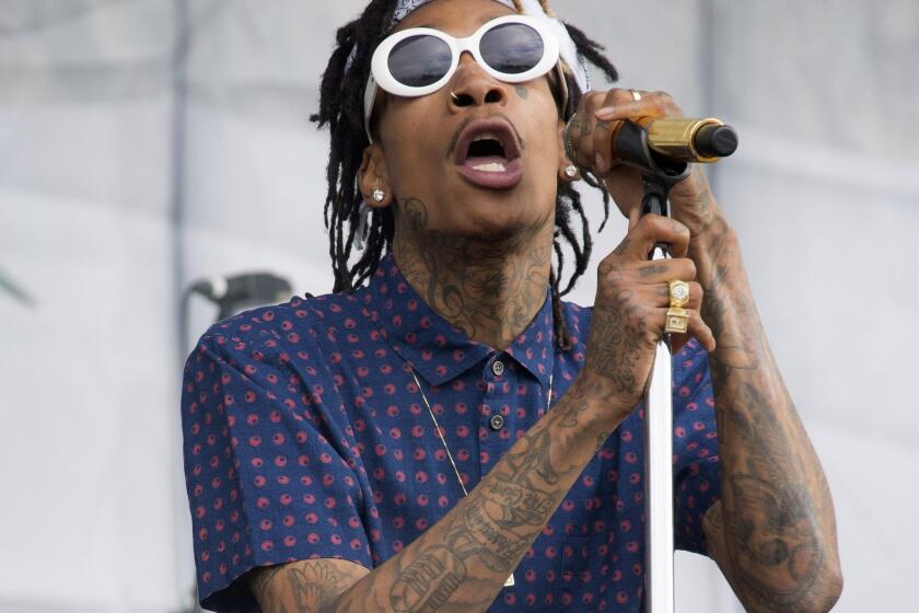 Rapper Wiz Khalifa performs at the Wireless Festival in London on July 5, 2014. Police say a 38-year-old man died Friday after being shot multiple times backstage at Khalifa's concert at a popular Silicon Valley music venue.