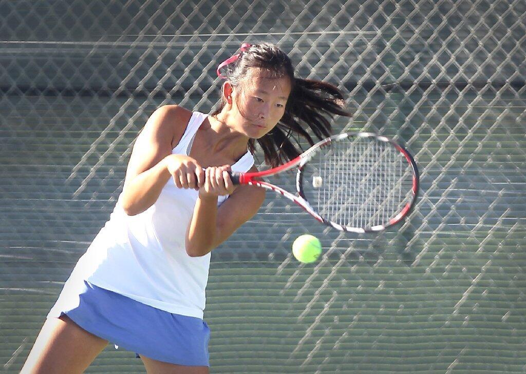 Corona del Mar High's Erica Chen rips a two-handed backhand against University.