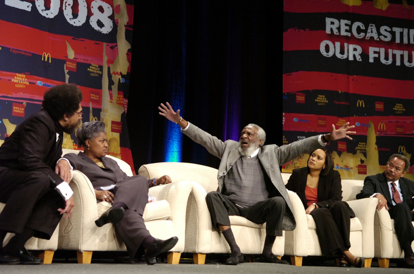Dick Gregory, center, gestures to the crowd at a"State Of The Black Union" symposium in 2008 in New Orleans.With Gregory were, from left,professor and author Cornel West, author and political analyst Donna Brazile, TransAfrica Forum Executive Director Nicole Lee and Morehouse College President Robert Michael Franklin.