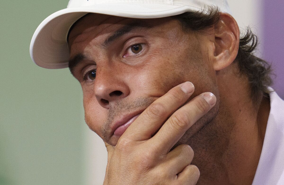 Spain's Rafael Nadal announces that he is withdrawing from the semi-final of the Gentlemen's Singles during a press conference at The All England Lawn Tennis Club, Wimbledon, Thursday, July 7, 2022. Rafael Nadal withdrew from Wimbledon on Thursday because of a torn abdominal muscle, announcing his decision a day before he was supposed to play in the semifinals. (Joe Toth/Pool Photo via AP)