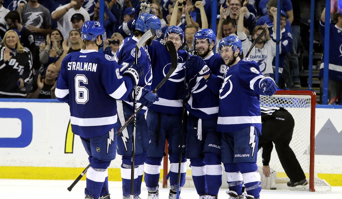 Tampa Bay Lightning right wing Nikita Kucherov second from right celebrates with teammates Tyler Johnson, right, and Anton Stralman, left, after scoring against the Montreal Canadiens during the third period of Game 6 of the Eastern Conference semifinals of Stanley Cup Playoffs on Tuesday. The Lightning win the series, 4-2, and eliminate the Canadiens.