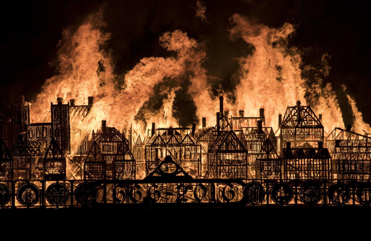 A model of London's 17th century skyline burns after it was set alight in a dramatic retelling of the story of the Great Fire of London.