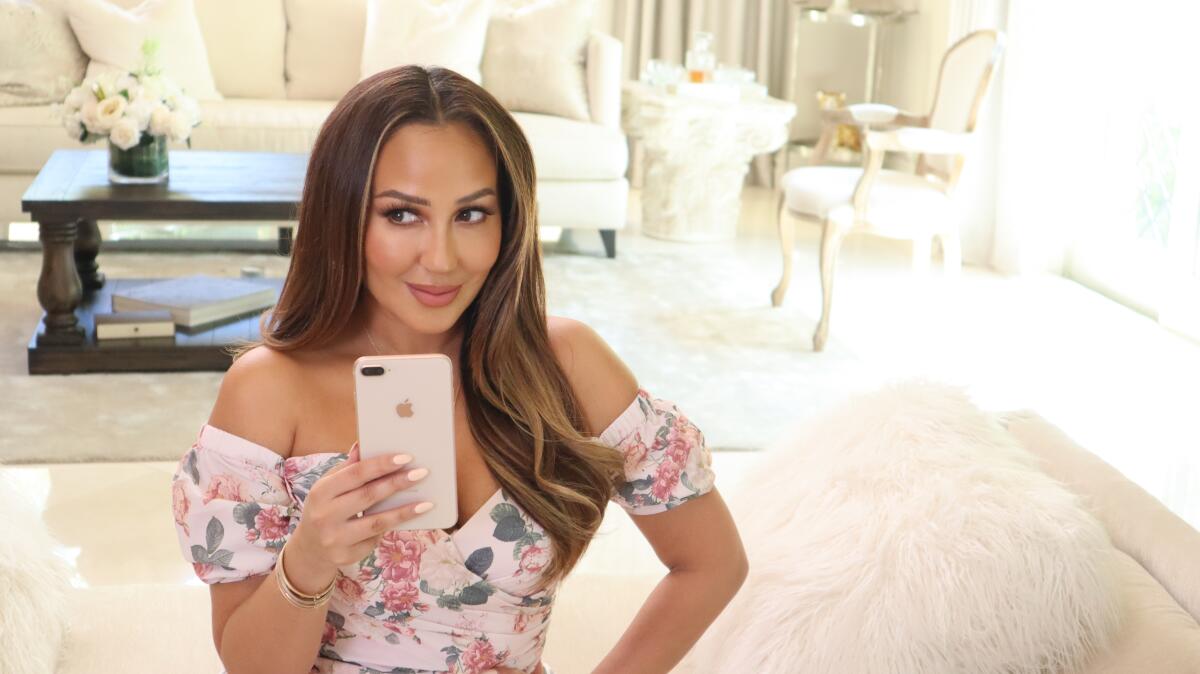 Influencer Adrienne Houghton gets ready to film herself at her then-home in Bel-Air. Before concerns were raised about the coronavirus' rapid spread in the community, Houghton's show, "All Things Adrienne," was filmed by a crew.