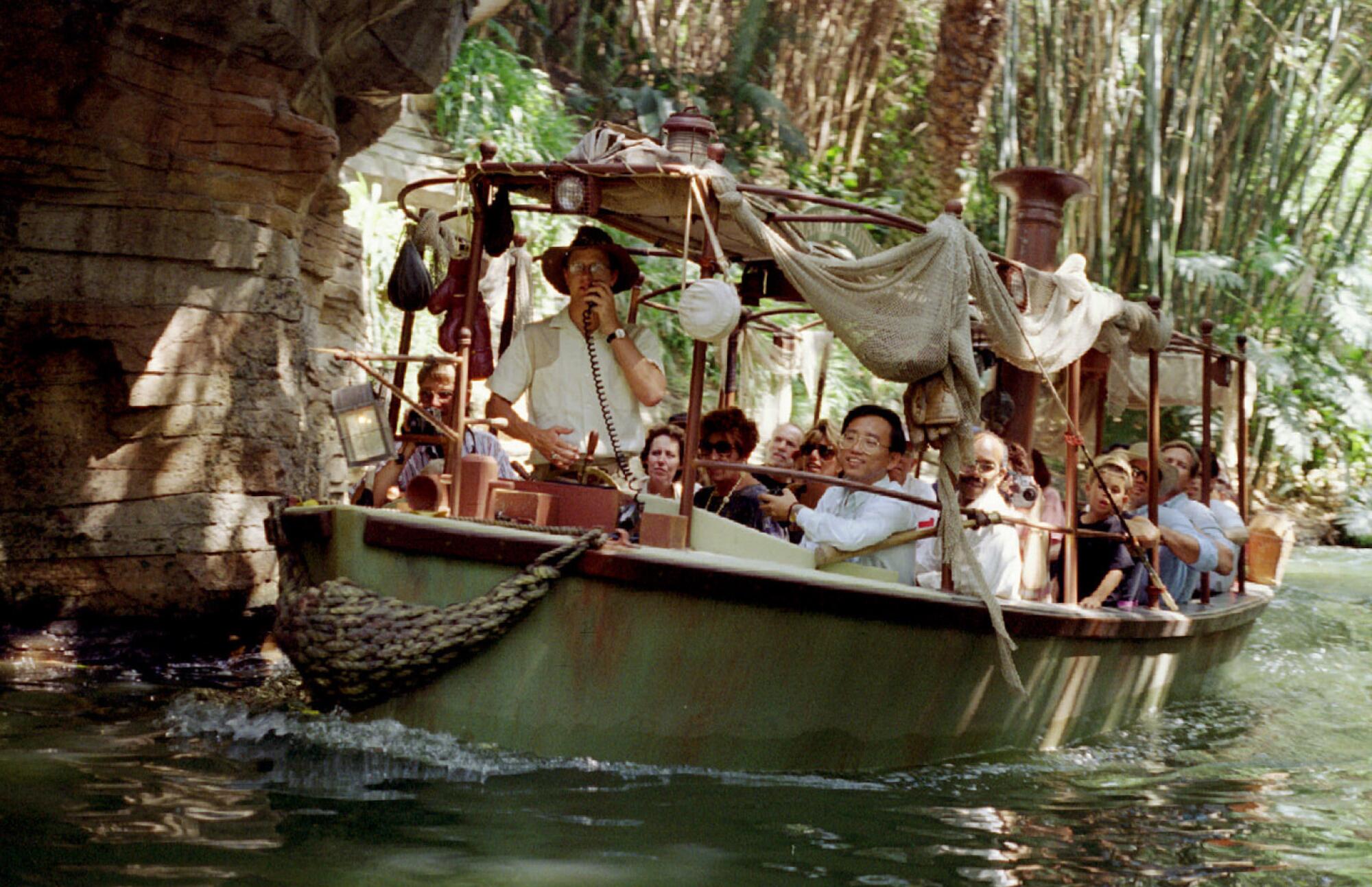 A Jungle Cruise boat filled with passengers at Disneyland.