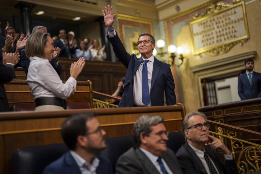 The leader of Spain's Popular Party Alberto Nunez Feijoo waves during his arrival at the Spanish parliament's lower house in Madrid, Spain on Tuesday, Sept. 26, 2023. The leader of Spain's conservatives will have his opportunity to form a new government this week in what has been preordained as a lost cause given his lack of support in the Parliament. (AP Photo/Bernat Armangue)