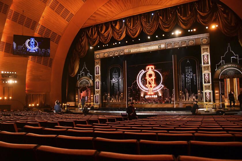 An elaborate stage and theater with velvet and gold accents