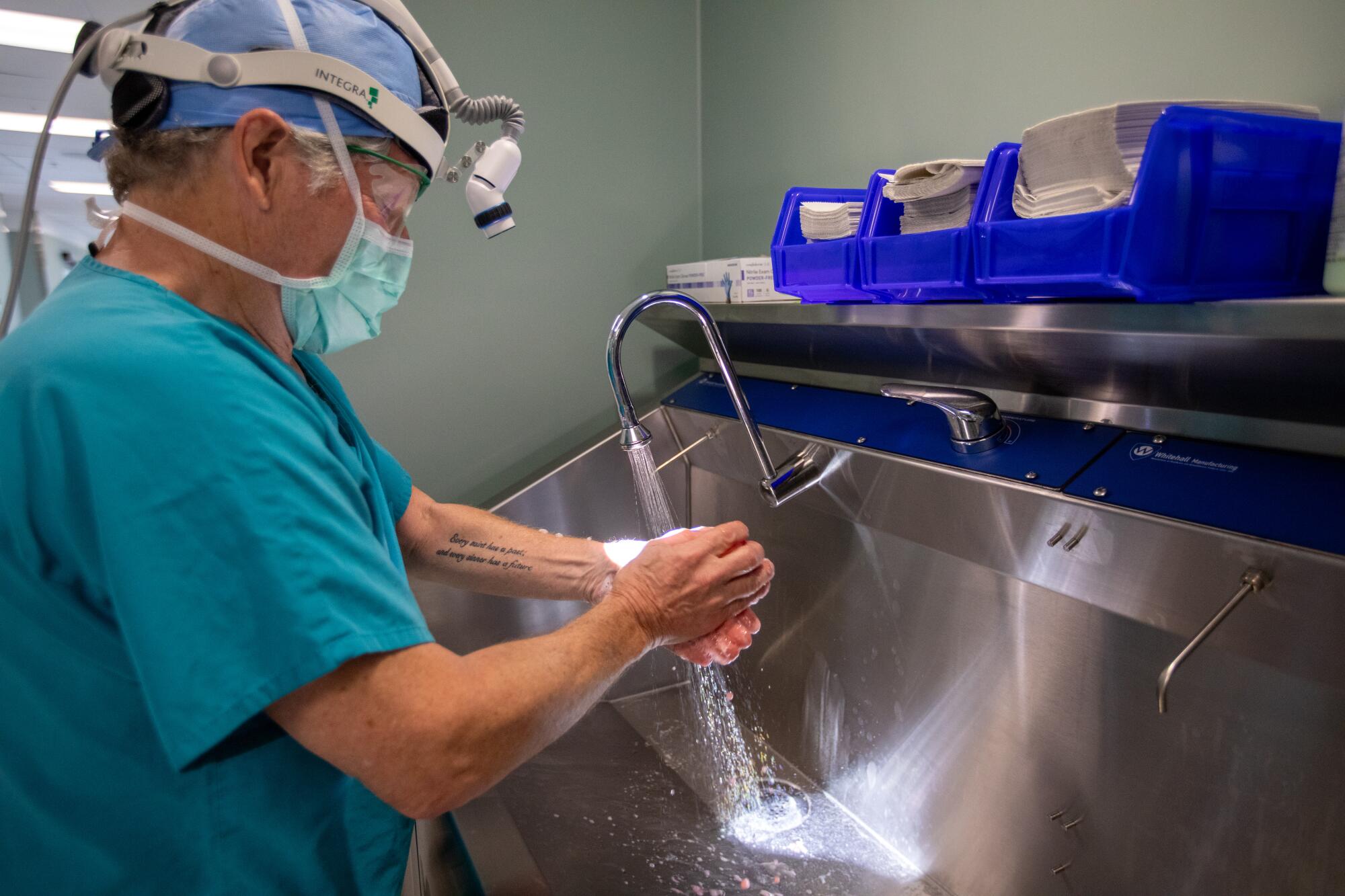 Dr. Donald Dafoe scrubs his hands before surgery to remove a liver from a donor 