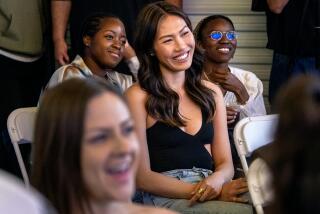 LOS ANGELES, CA - JUNE 29, 2023: Los Angeles based model Julia Lee, middle, an Asian American in the fashion industry, attends the Mid-City Comedy show at GenQ Studio on June 29, 2023 in Los Angeles, California. She embraces her Vietnamese/Chinese background and the need to continue calling out hate amid a rise in anti-Asian sentiment and hostility toward other historically targeted groups. (Gina Ferazzi / Los Angeles Times)