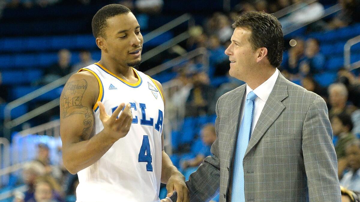 UCLA guard Norman Powell, left, speaks with Coach Steve Alford during a win over Cal State Fullerton on Dec. 3. The two will lead the Bruins into their Pac-12 Conference opener on Friday against Colorado.