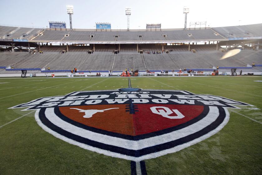 FILE - In this Oct. 10, 2020, file photo, The Red River Showdown logo is displayed on the field of the Cotton Bowl, prior to an NCAA college football game between the University of Texas and Oklahoma, in Dallas. Texas and Oklahoma made a request Tuesday, July 27, 2021, to join the Southeastern Conference — in 2025 —- with SEC Commissioner Greg Sankey saying the league would consider it in the “near future.” (AP Photo/Michael Ainsworth, File)
