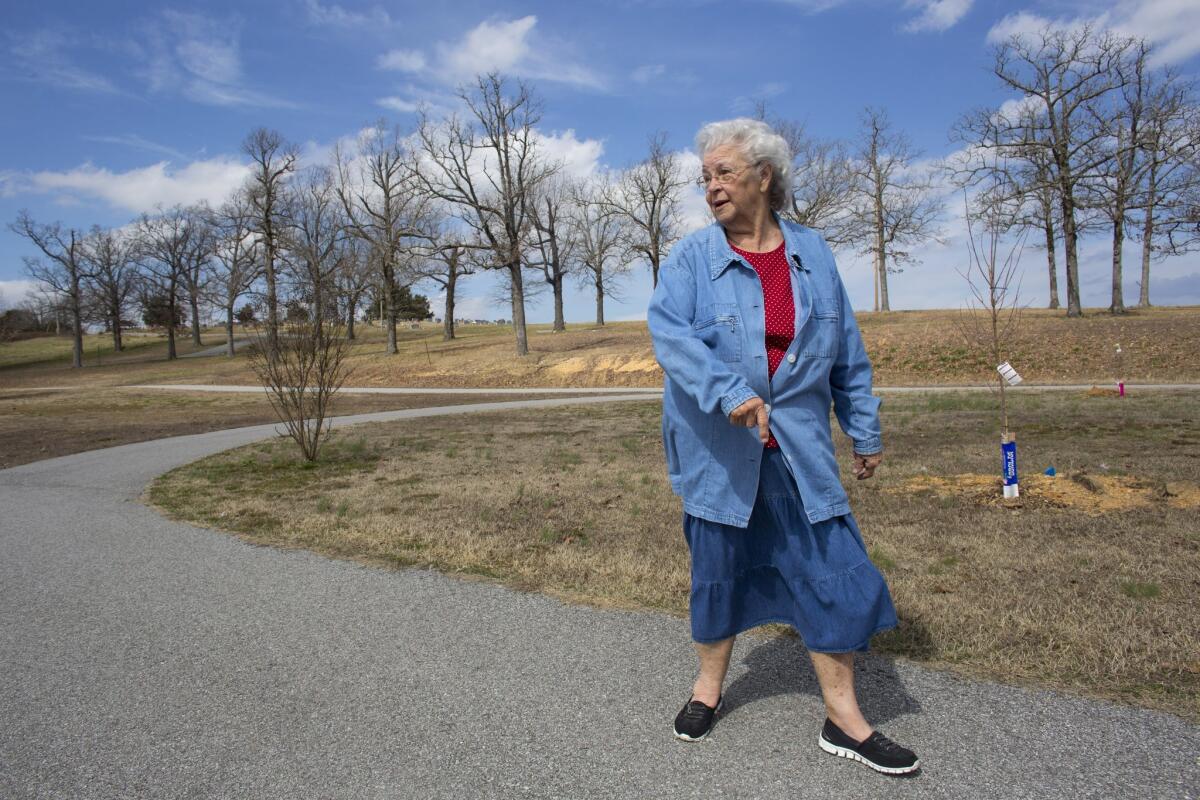 Winnie Abbott walks a short trail at City Park in Cave City, Ark. The 80-year-old great-grandmother recently had her knee replaced by a surgeon participating in a statewide effort in Arkansas to improve care.