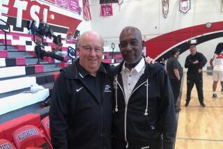 Westchester coach Dewitt Cotton (right) with former coach Ed Azzam. Cotton's Comets clinched the Western League title.