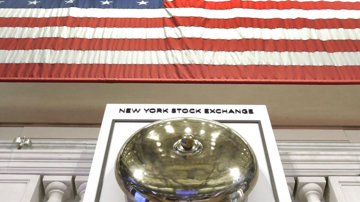An American flag hangs above the bell podium on the floor of the New York Stock Exchange.