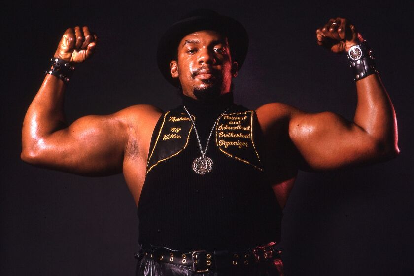 Big Willie Robinson, president of the International Brotherhood of Stree Racers, flexes his muscles during a photo shoot.in 1974.