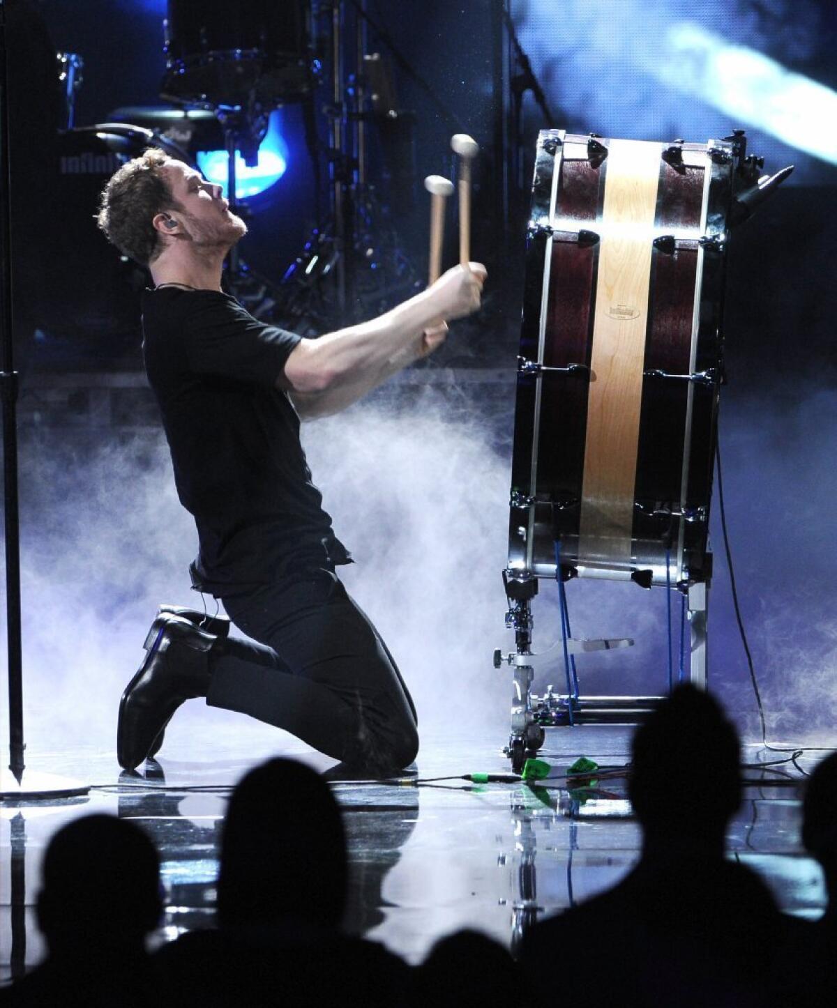 Singer Dan Reynolds of Imagine Dragons performs during the 2013 American Music Awards at Nokia Theatre L.A. Live on Nov. 24, 2013, in Los Angeles,