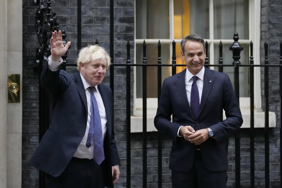 Britain's Prime Minister Boris Johnson, left, greets Greek Prime Minister Kyriakos Mitsotakis at Downing Street in London, Tuesday, Nov. 16, 2021. (AP Photo/Kirsty Wigglesworth)