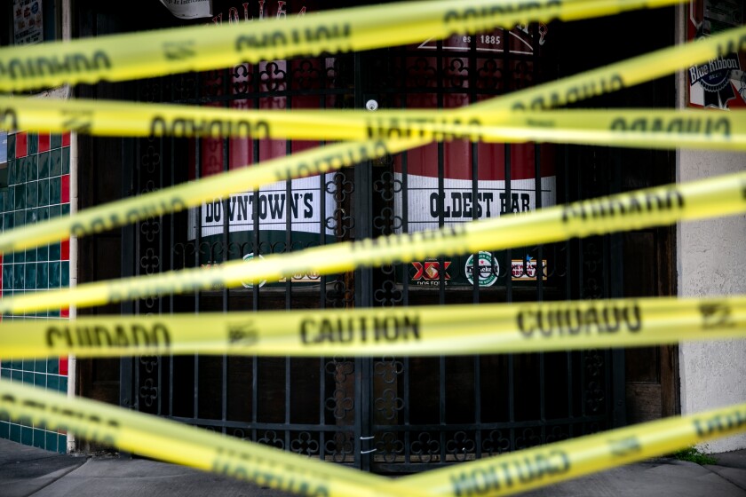Tivoli Bar and Grill in downtown San Diego is closed and its front door blocked off by caution tape on April 29, 2020.