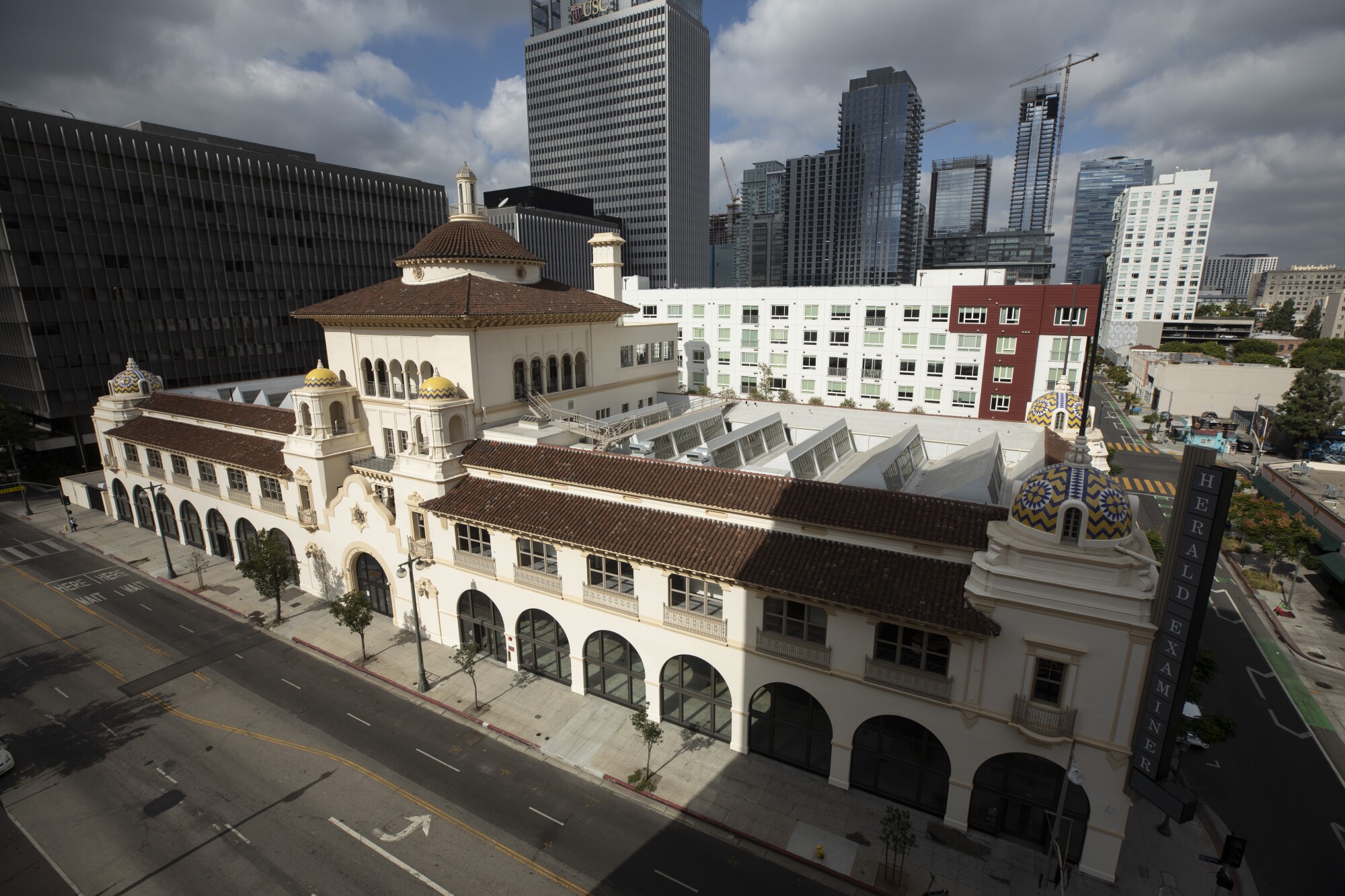 An image taken from above shows the facade of the freshly renovated Herald-Examiner building in sunlight