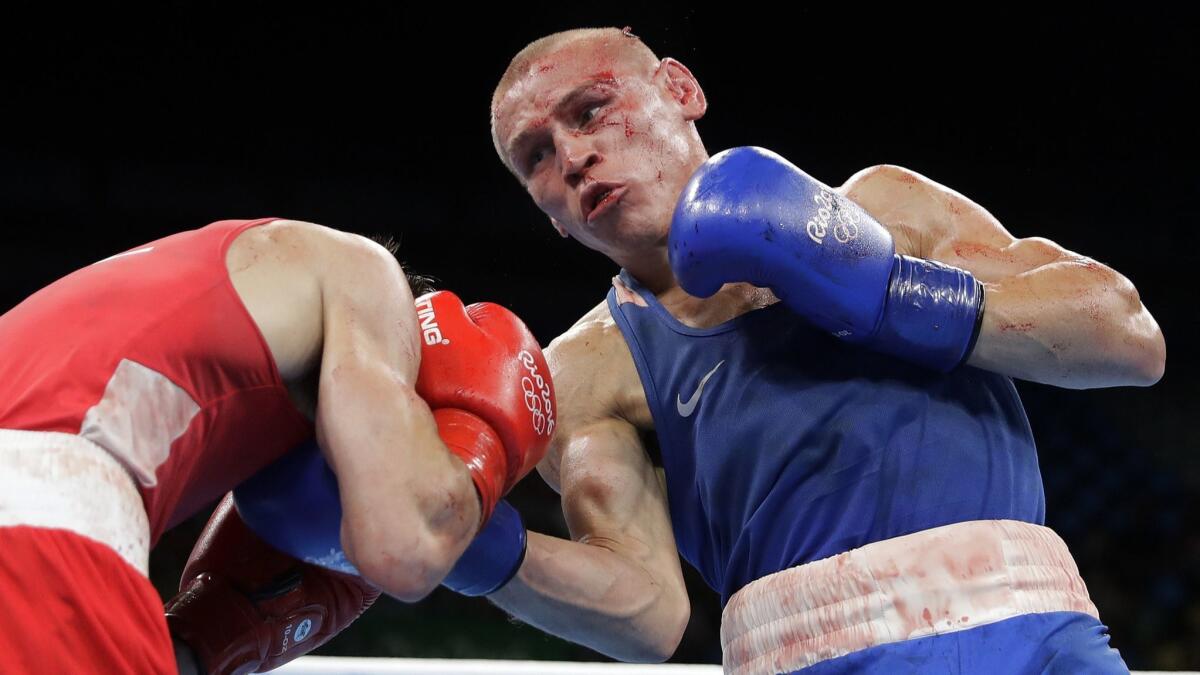 Russia's Vladimir Nikitin, right, fights Ireland's Michael John Conlan during the men's bantamweight quarterfinals at the 2016 Summer Olympic Games in Rio de Janeiro.