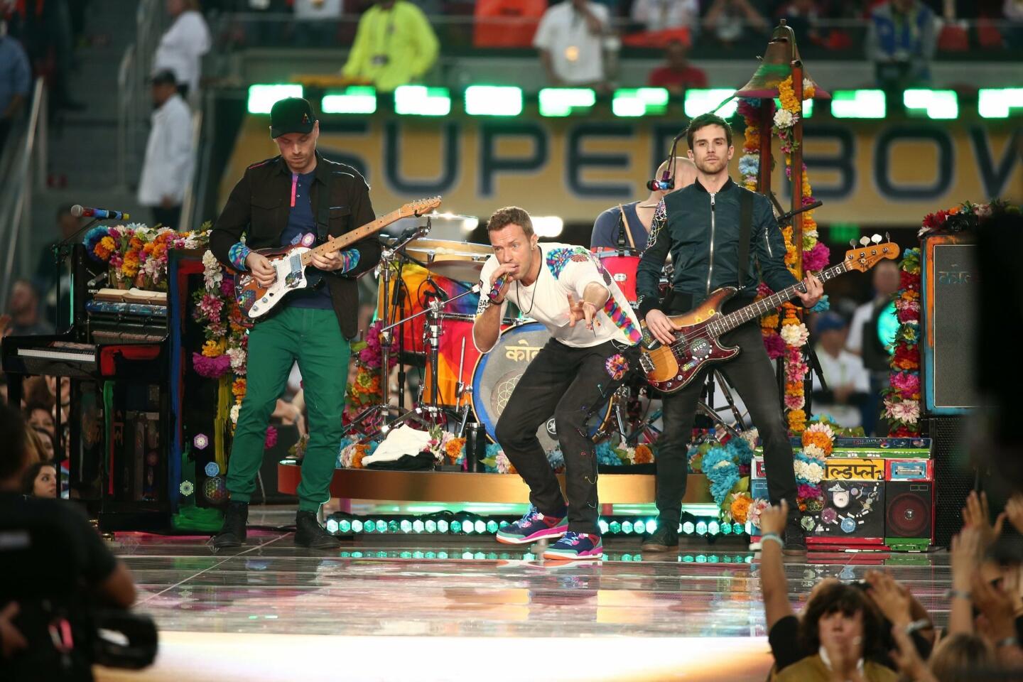 Jonny Buckland, Chris Martin, Guy Berryman and Will Champion of Coldplay perform onstage during the Pepsi Super Bowl 50 Halftime Show at Levi's Stadium in Santa Clara, California. Christopher Polk/Getty Images