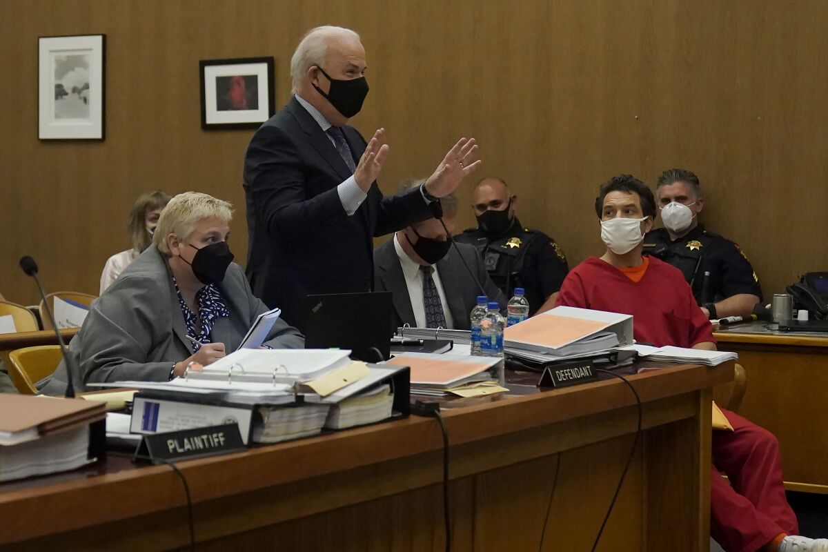 Scott Peterson, second from right, listens as his attorney, Pat Harris, standing, speaks during a hearing during a hearing at the San Mateo County Superior Court in Redwood City, Calif., Tuesday, March 1, 2022. Also pictured are attorneys Shelley Sandusky, left, and Cliff Gardner, seated at center, both representing Peterson. Lawyers trying to overturn Peterson’s conviction in the sordid slaying of his pregnant wife 20 years ago have completed their questioning without shaking a former juror. Richelle Nice is sticking to her crucial testimony that she acted properly before and during his 2004 trial. (AP Photo/Jeff Chiu, Pool)