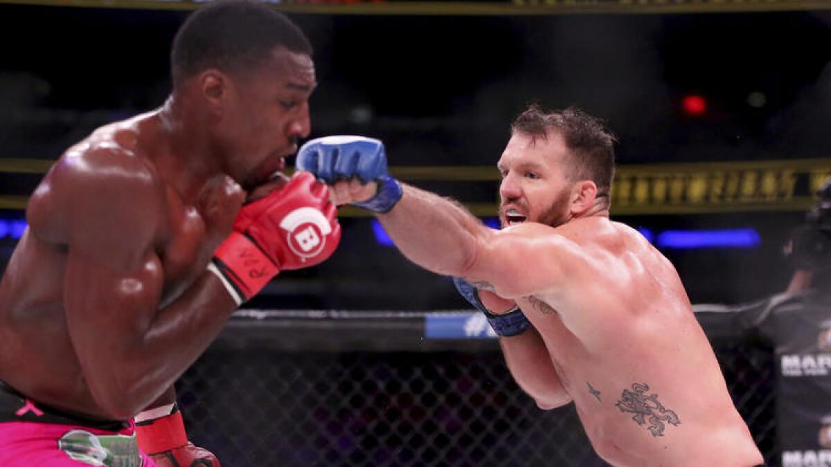 Ryan Bader, right, goes on the offensive against Phil Davis during their light-heavyweight title fight at Bellator NYC. To see more images, click on the photo above.