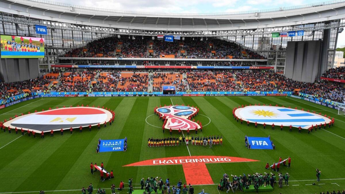 The teams from Egypt and Uruguay line up for the national anthems before the start of their World Cup match at the Yekaterinburg Arena on June 15.
