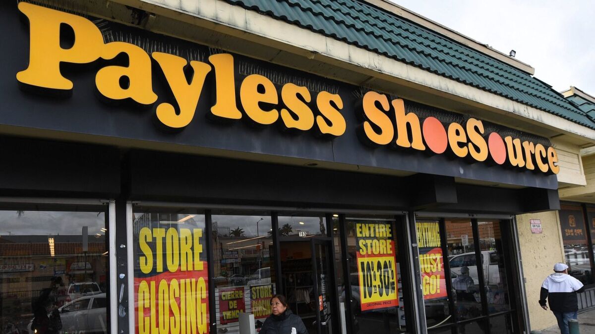 Shoppers leave a Payless shoe store in Los Angeles on Sunday.