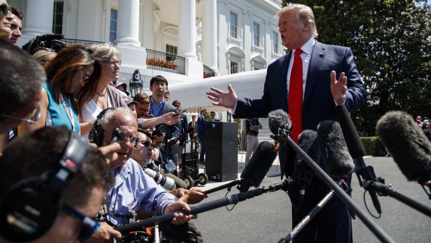 President Trump talks to reporters outside the White House on July 5 before departing for his golf club in Bedminster, N.J.