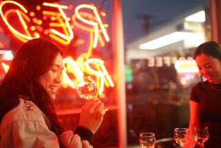 Los Angeles, CA - March 21: Camly Nguyen smiles in between sipping Jeremie Hutchet Pet Nat alongside Jenevieve Heo at Red Room on Thursday, March 21, 2024 in Los Angeles, CA. (Michael Blackshire / Los Angeles Times)