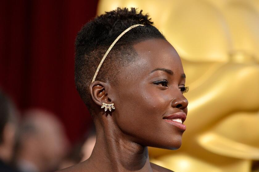 Lupita Nyong'o wears a Fred Leighton gold and diamond headband at the Academy Awards.