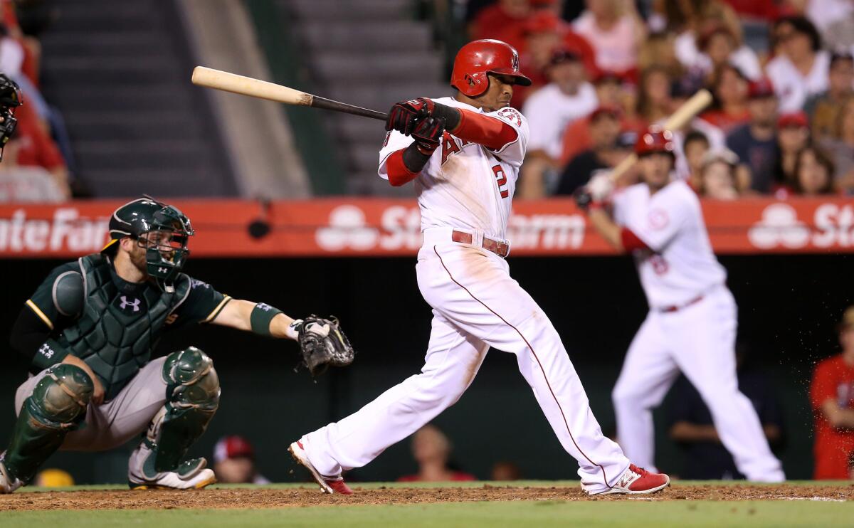 Erick Aybar drives in the first of two fourth-inning runs for the Angels against Oakland on Saturday night.